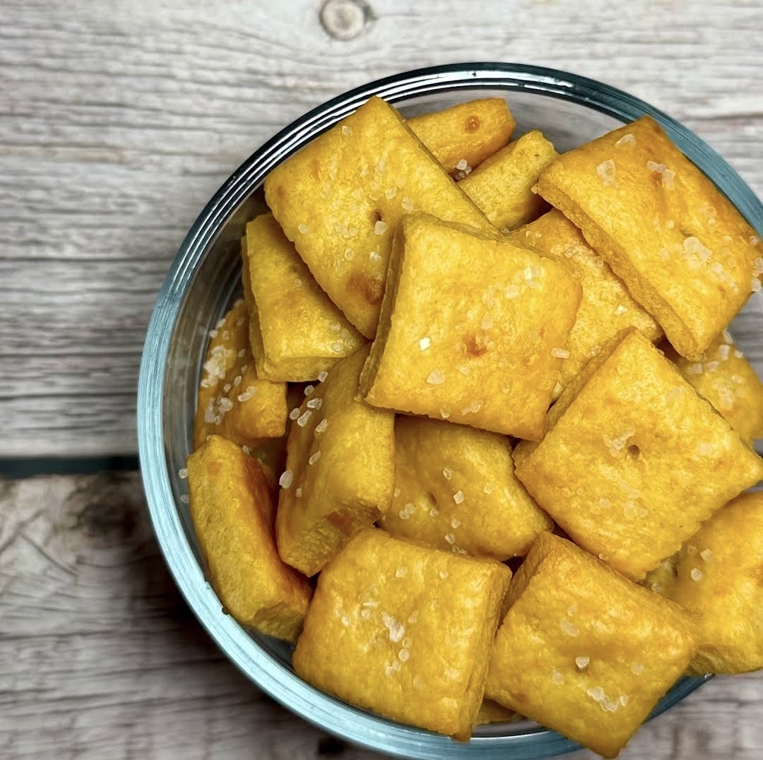 Bowl of golden sourdough cheddar crackers with sea salt